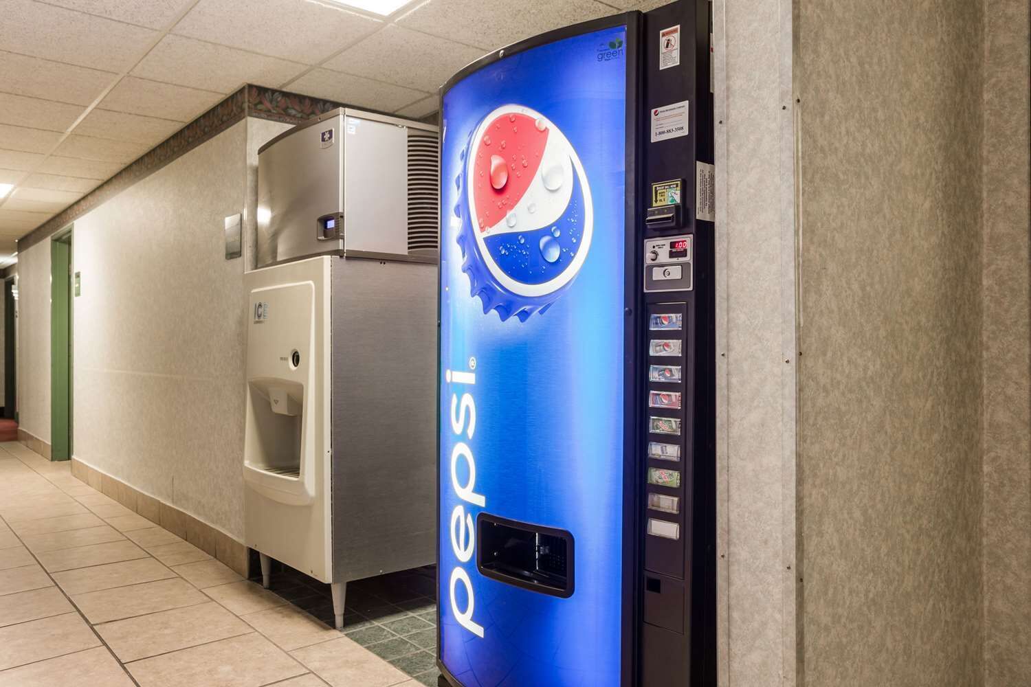 A vending machine with a Pepsi logo, a water dispenser, and a digital display.