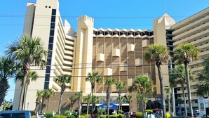 A hotel with a modern architectural design, featuring a prominent tower and a patterned facade.