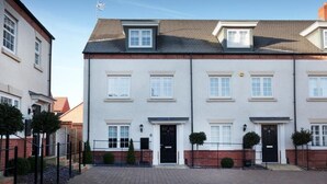 A two-story residential building with a symmetrical facade, a central entrance, and a small front garden. - The Terrace (Derby)
