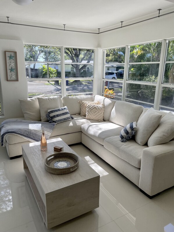 Relax in this stylish living room with a sofa, coffee table, and picture frame, offering a view of the outdoors.