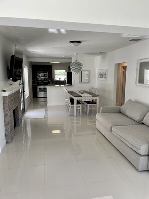 Enjoy a spacious living area with a central dining space and comfortable seating, perfect for relaxing and socializing.