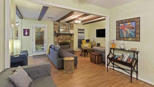 A spacious living area with a fireplace, sofas, and a coffee table.