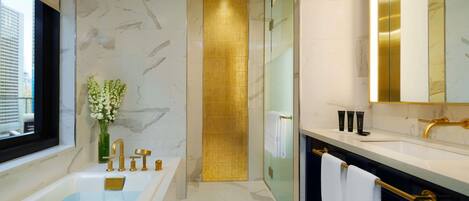 Un baño moderno con bañera, tocador con espejo y cabina de ducha.