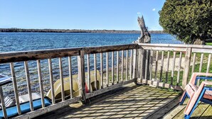 A wooden deck with a view of a lake and boats. - Deluxe Beachfront Villa 3 Bedroom, sleeps 10 (Mar)