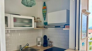 A compact kitchen with a sink, a coffee maker, and a microwave. - Martinique!  Beautiful, fully renovated studio with sea view (ANSE MITAN - LES 3 ILETS)