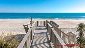 A wooden boardwalk leading to a beach with clear blue water and a sandy shore. - Vitamin Sea - Oceanfront, 5 BR Home in Surf City - Elevator! (Surf City)
