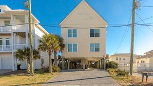A two-story building with a central entrance and a covered walkway leading to the main door. - Vitamin Sea - Oceanfront, 5 BR Home in Surf City - Elevator! (Surf City)
