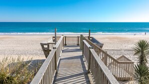 A wooden boardwalk leading to a beach with clear skies. - Vitamin Sea - Oceanfront, 5 BR Home in Surf City - Elevator! (Surf City)