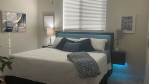 A bedroom with a bed, nightstands, a ceiling fan, and a window with blinds. - Phoenix Oasis - Ah! Ahwatukee! (Phoenix)