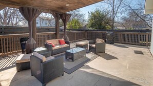 An outdoor patio with wicker furniture, a ceiling fan, and a view of the surrounding area. - Lovely 3 BR Home Only 9 Minutes From Downtown (San Antonio)