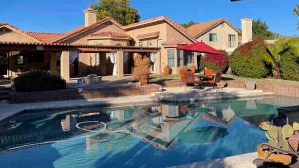 A house with a swimming pool, outdoor furniture, and a red umbrella. - Waterfront, LuxuryVilla with Private Pool- (Chandler)