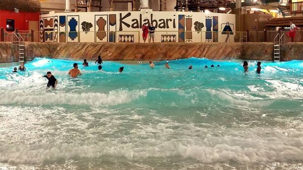A pool area with a mural of animals and the word "Kalabari" on the wall. - SUMMER IN THE POCCONOS ! (Tafton)
