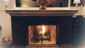 A fireplace with a mantel, a hanging sail decoration, and a framed mirror above it. - SUMMER IN THE POCCONOS ! (Tafton)