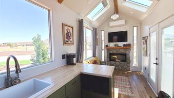 Fridge, microwave, coffee/tea maker, cookware/dishes/utensils