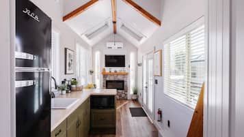 Fridge, microwave, coffee/tea maker, cookware/dishes/utensils