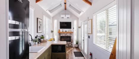 Fridge, microwave, coffee/tea maker, cookware/dishes/utensils