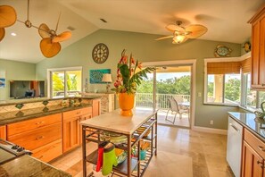 Enjoy cooking in this well-equipped kitchen with a central island, sink, and range hood.