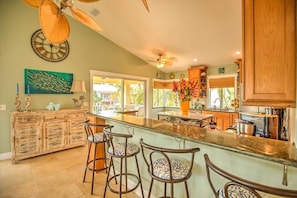 Enjoy cooking in this well-equipped kitchen with a central island and bar stools.
