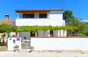 Stunning two-story building with a balcony and garden area.