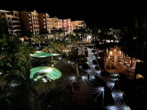 A nighttime view of a resort with multiple buildings, palm trees, and illuminated pathways. - The Islands of Loreto Resort and Spa (Loreto)