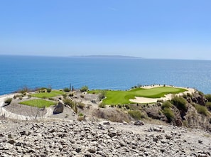A coastal golf course with a clear view of the sea and distant mountains. - The Islands of Loreto Resort and Spa (Loreto)