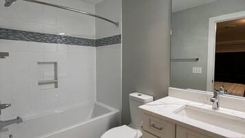 Combined shower/bathtub, towels, soap, toilet paper