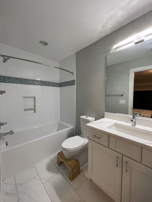 Combined shower/bathtub, towels, soap, toilet paper