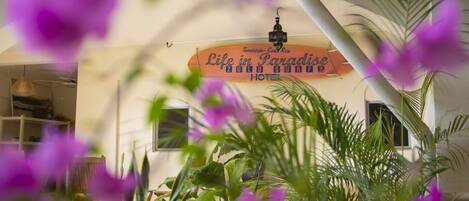 A hotel interior with a sign reading "Life in Paradise Zulu Sun Hotel."