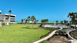 A resort with a pool, palm trees, and a view of the ocean. - Gulfside Place #107 ~ 3br/3ba - Gulf front living at its finest (Sanibel)