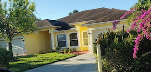 A residential house with a front yard, a driveway, and a garage.