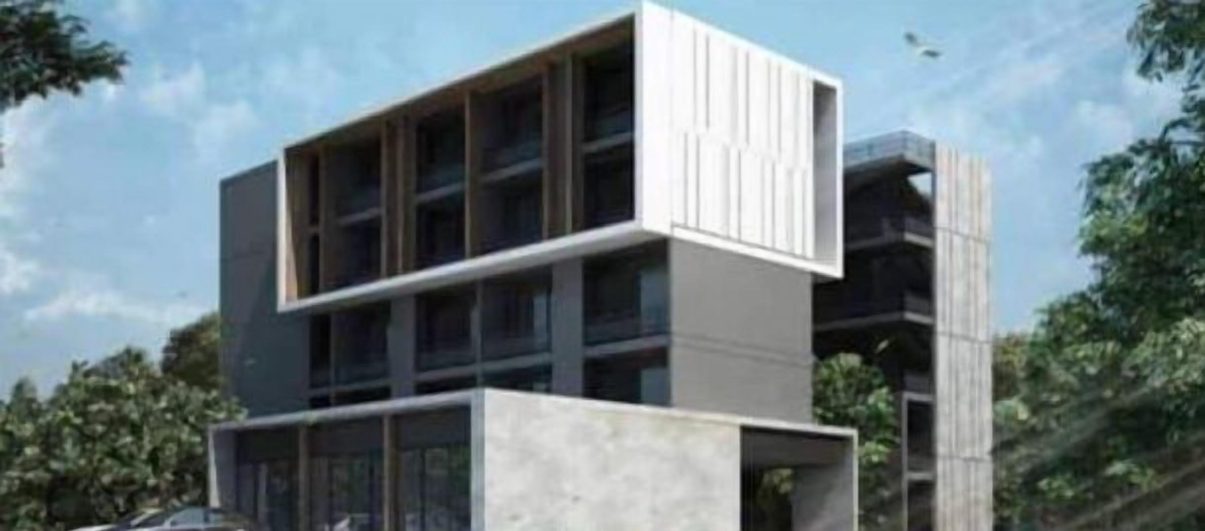 Um edifício moderno com telhado plano, grandes janelas e design minimalista.