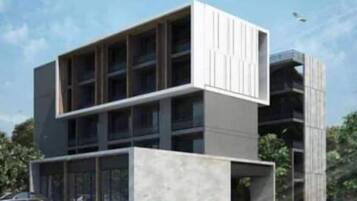 Um edifício moderno com telhado plano, grandes janelas e design minimalista.