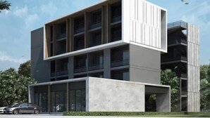 A modern multi-story building with a flat roof, large windows, and a minimalist design. - Aqua Residences (Bangkok)