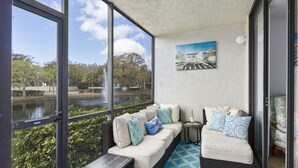 A balcony with two sofas, a small table, and a painting. - Bradenton Beach/Anna Maria Island, IMG Academy, Longboat Key, Sarasota (Bradenton)