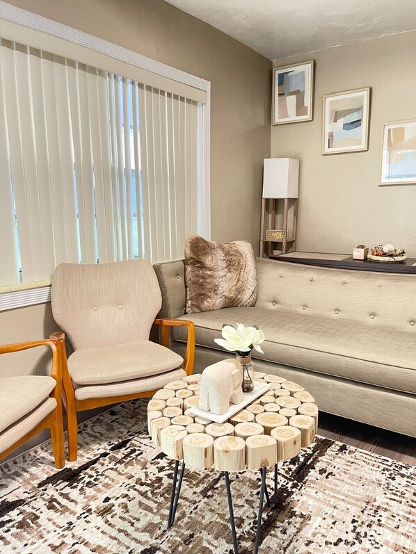 Relax in this inviting living room with a comfortable sofa, armchairs, and a coffee table.