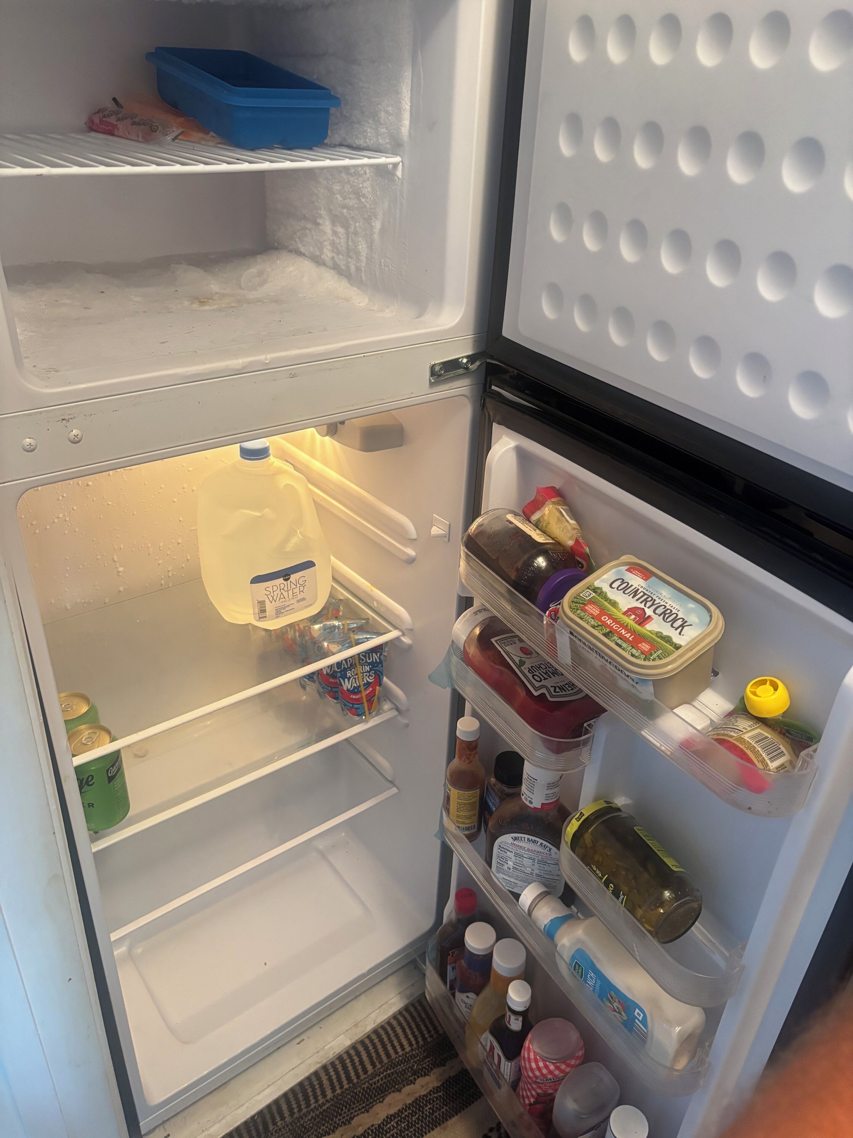 An open refrigerator with various food items and containers.
