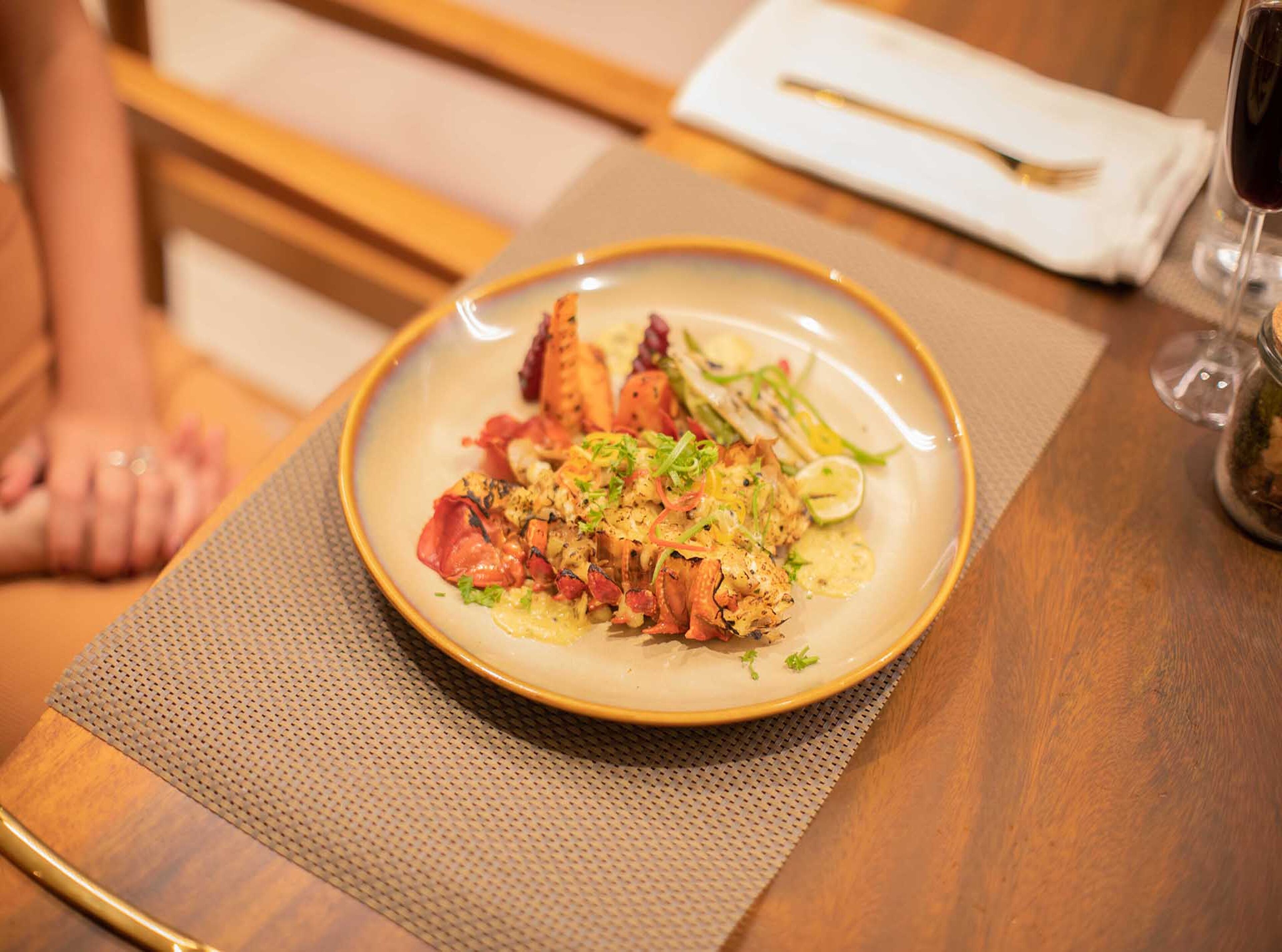 A plate of food on a table with a placemat.