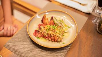 A plate of food on a table with a placemat.