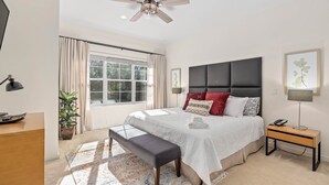 A bedroom with a large bed, a ceiling fan, a bedside table with a lamp, a window with curtains, and a potted plant. - ♥︎ Disney-3 miles ♥︎ Private HotTub ♥︎Top Resort♥︎ (Kissimmee)