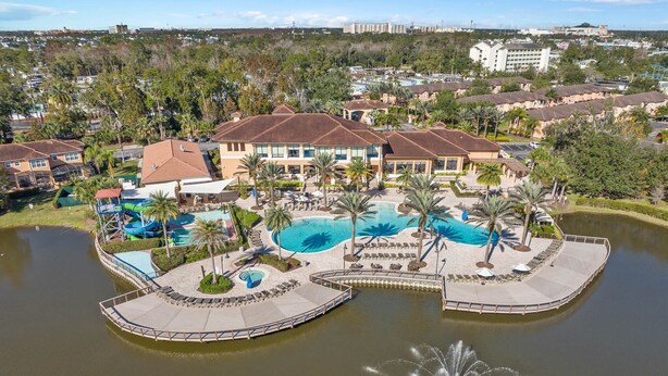 A resort with multiple swimming pools, a water fountain, and a dock. - ♥︎ Disney-3 miles ♥︎ Private HotTub ♥︎Top Resort♥︎ (Kissimmee)