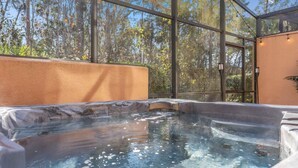 A hot tub with a glass enclosure, surrounded by a wooden deck and a view of trees. - ♥︎ Disney-3 miles ♥︎ Private HotTub ♥︎Top Resort♥︎ (Kissimmee)