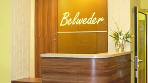 A reception desk with a wooden finish and the name 'Belwedder' displayed above it. - BELWEDER (Duszniki Zdroj)