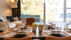 A dining area with a table set for two, clear glass light fixtures, and a view of the outdoors. - "Apartment Higueron Wave 1" with Sea View, Pool, Wi-Fi & Terrace (Fuengirola)
