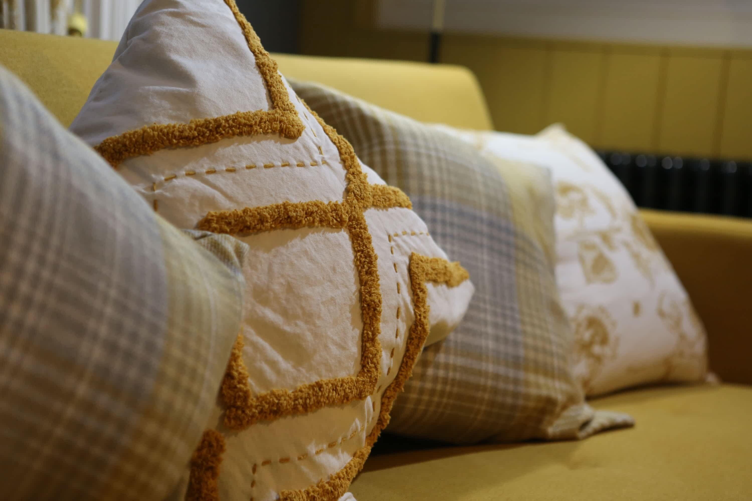 A close-up of a sofa with patterned cushions.