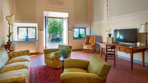 A spacious living room with a large TV, comfortable seating, and a view through the glass doors. - The Chapel - ancient little country church (GRASSINA)