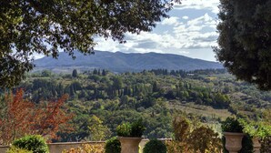 A view of a mountainous landscape with a garden in the foreground. - The Chapel - ancient little country church (GRASSINA)