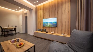Apartment, 1 Bedroom, Balcony | Living area | 50-inch Smart TV with cable channels, TV