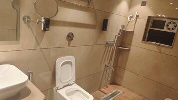 A modern bathroom with a toilet, bidet, and shower.