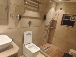 A modern bathroom with a toilet, bidet, and shower.