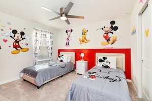 A room with two beds, a ceiling fan, Mickey Mouse wall decals, and a window with curtains. - Disney Fireworks By The Pool! 18 guests? No Problem! Must See Discounts! (Davenport)